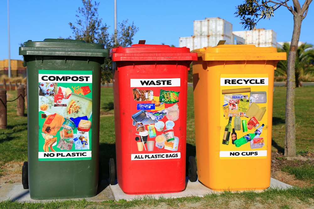 Colour-coded recycling bins lined up outdoors