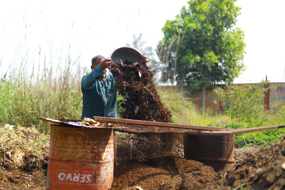 Gardener working with organic compost outdoors