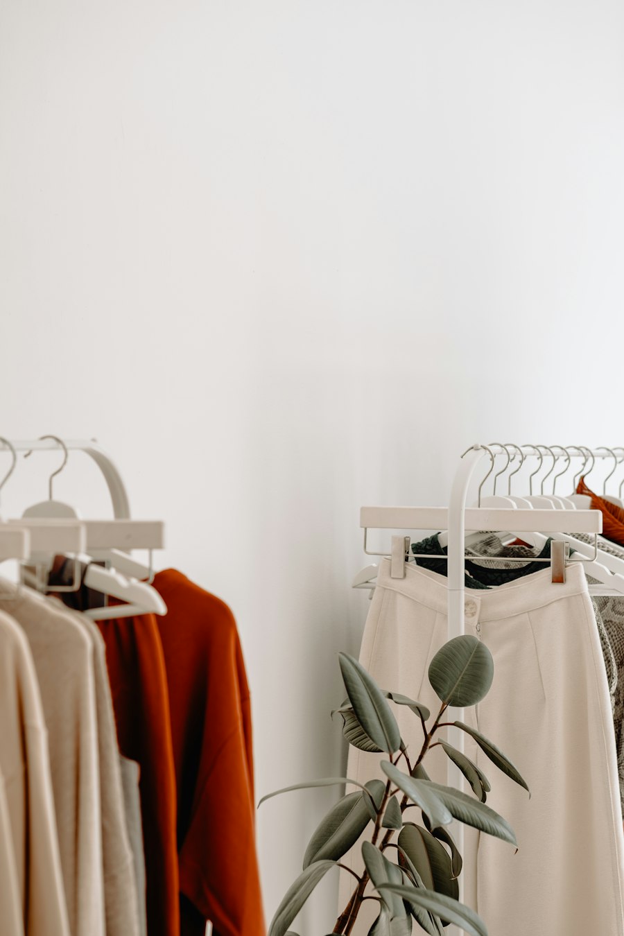 Neutral toned garments hanging on a clothing rack