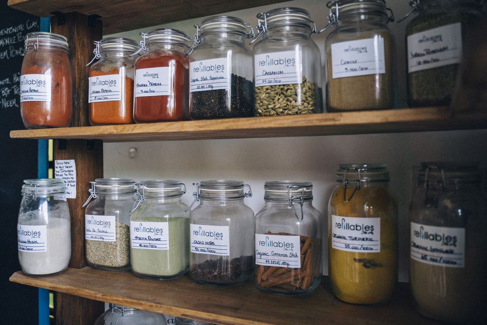 Shelves of labelled glass refill jars with grains and spices