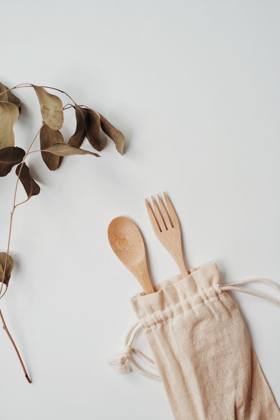 Wooden spoon and fork tucked in a cotton pouch